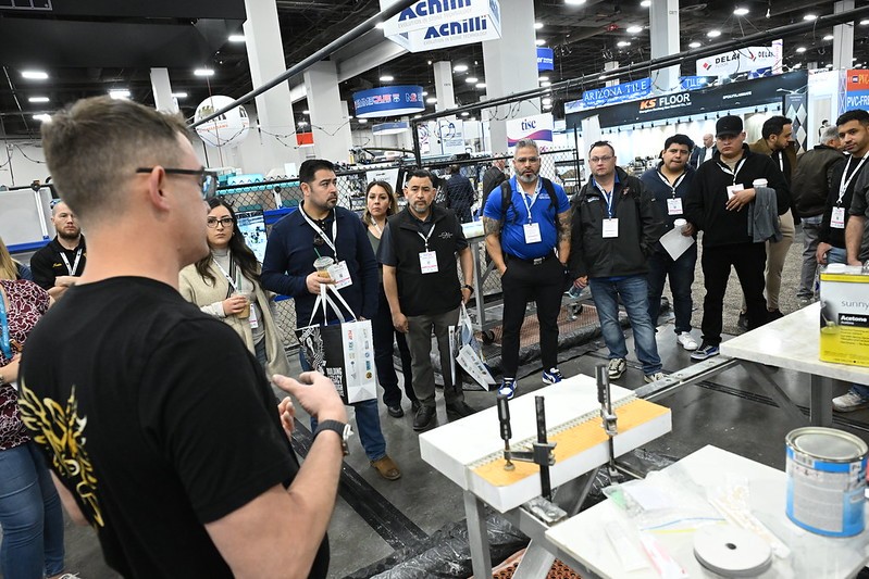 Exhibitor showing products to contractors at tise