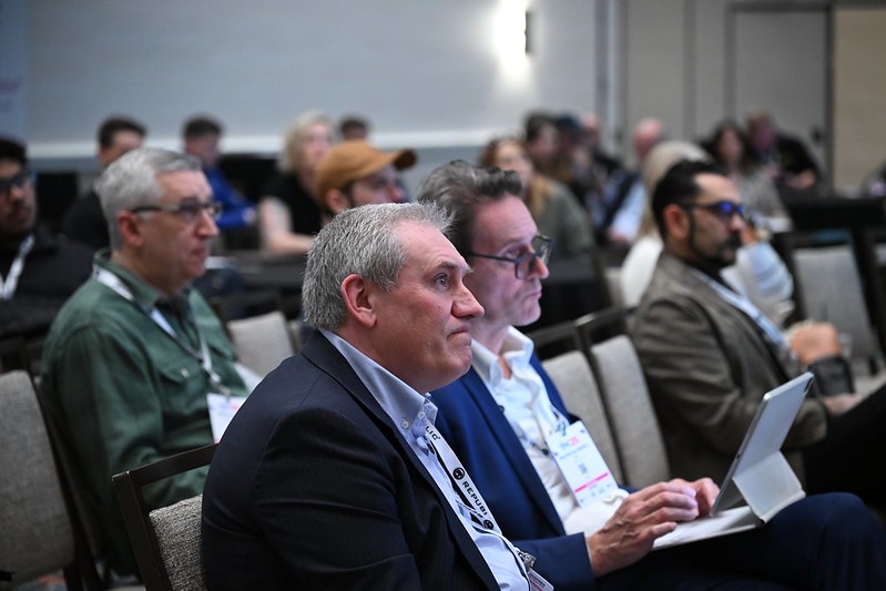 Education session attendee at tise listenting attentively 
