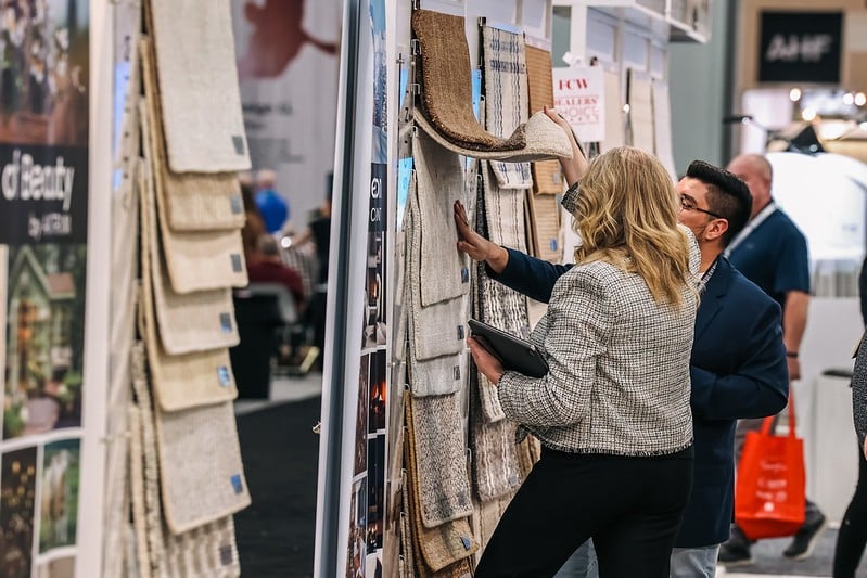 Attendees looking at carpet samples