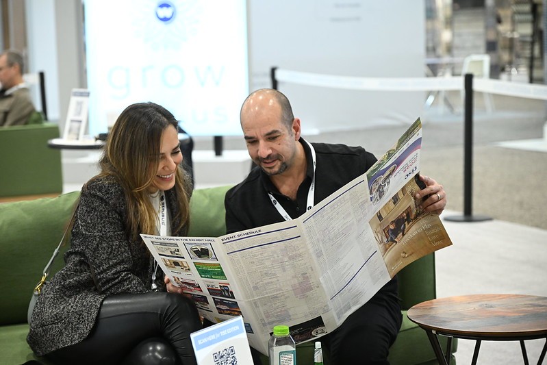 Attendees looking at a tise show guide