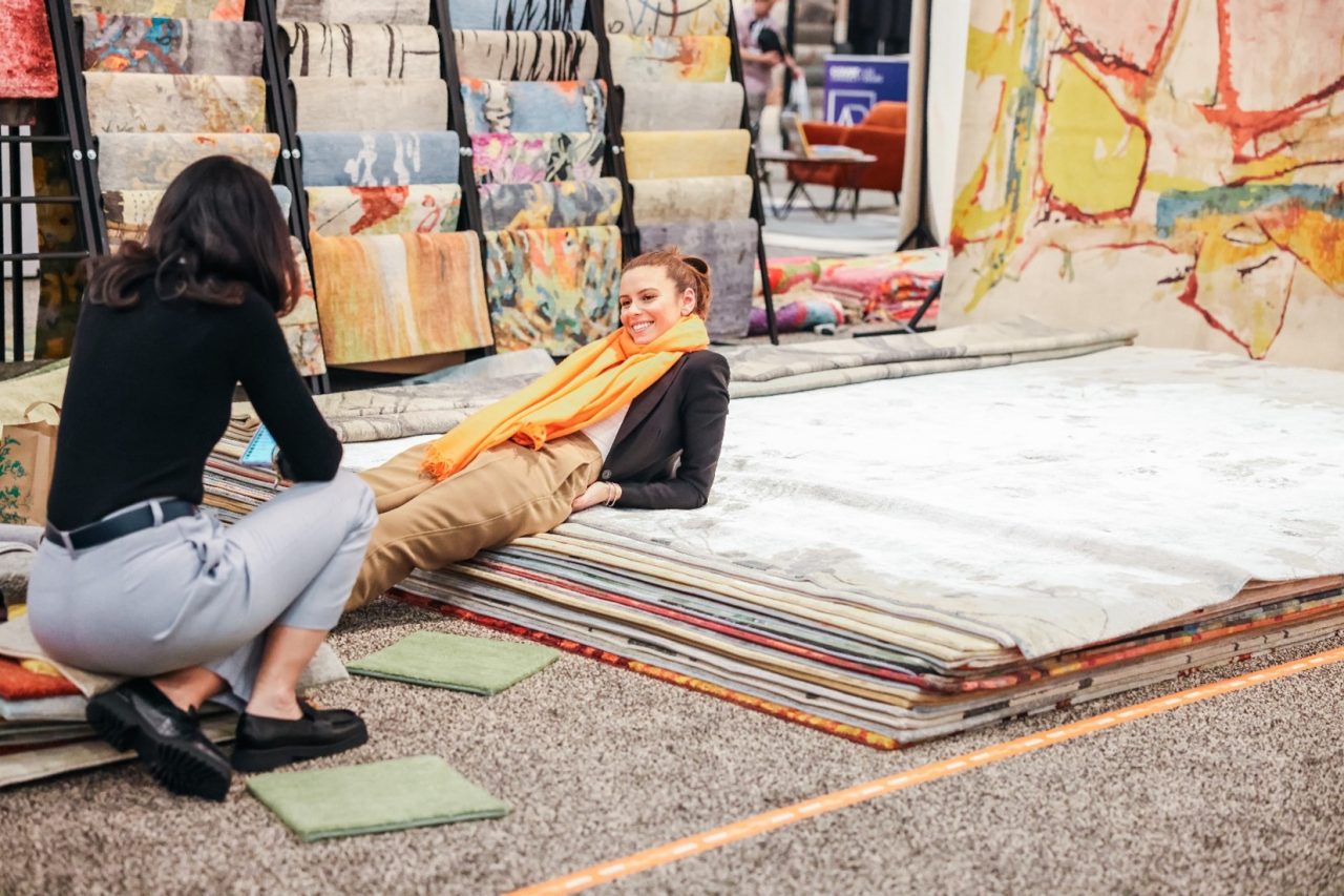 Person laying on Rugs at TISE 2024